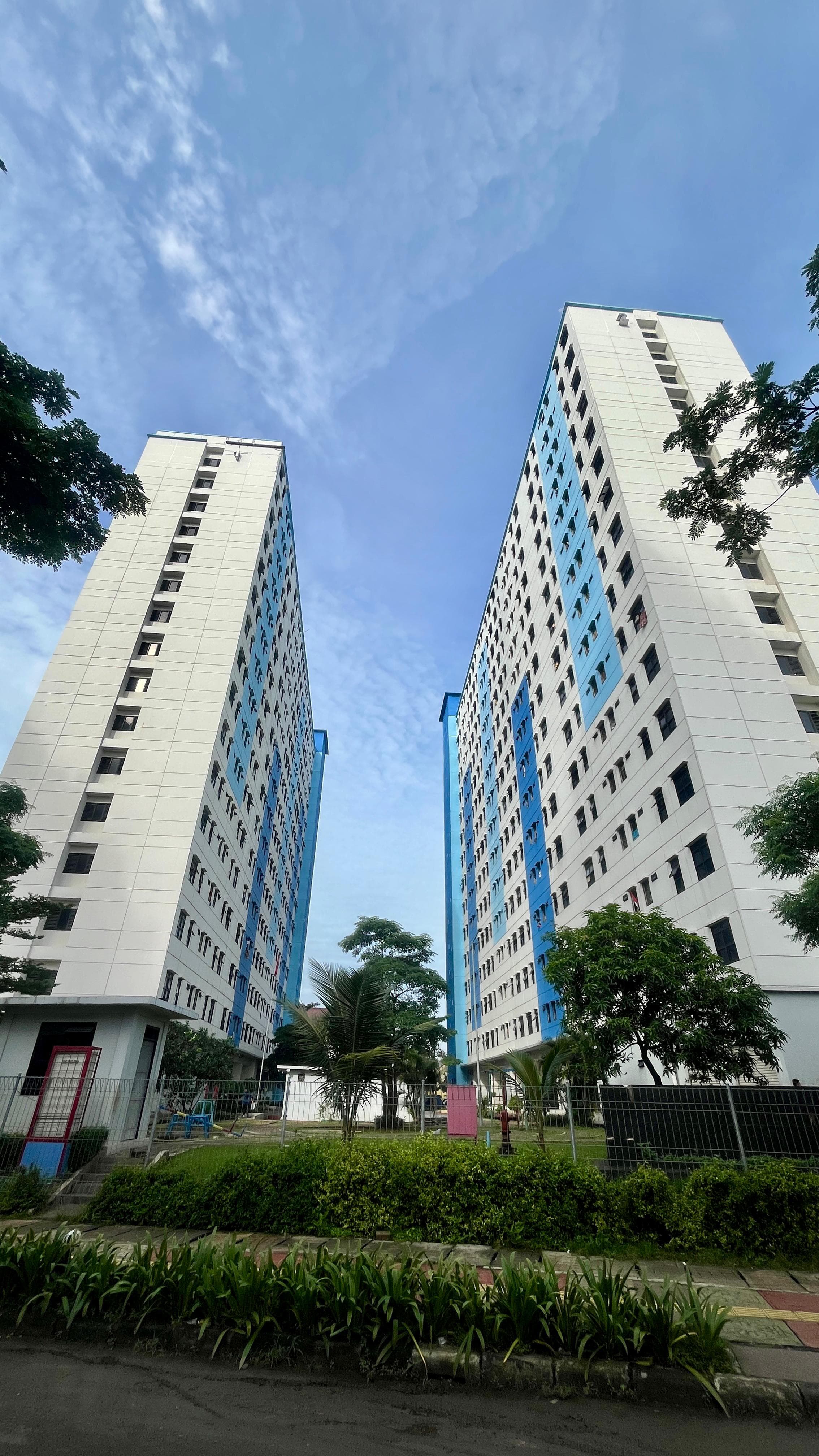 Modern apartment building with clean lines and blue sky background